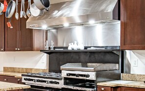 Enjoy cooking in this well-equipped kitchen with a range, sink, and ample storage.