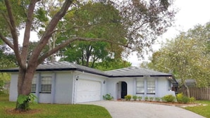 A single-story house with a garage, a front porch, and a driveway.