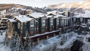 A multi-story hotel with a symmetrical facade, large windows, and a central entrance.