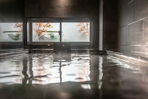 A large indoor swimming pool with clear glass walls, allowing views of outdoor foliage. - Super Hotel Hiroshima Natural Hot Springs Yagenboridori (Hiroshima)
