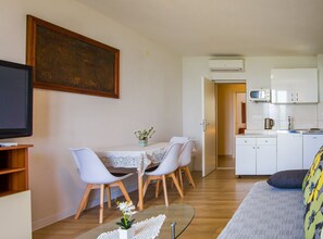 Apartment (One Bedroom Apartment with Balconies) | Living room | Flat-screen TV