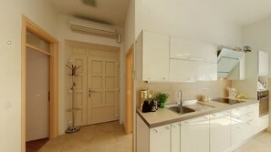 Apartment (Two-Bedroom Apartment with Balcony) | Private kitchen | Fridge, microwave, stovetop, dishwasher