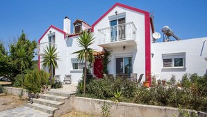 A two-story house with a red roof, white walls, and a balcony. - Villa Marilia - Lux home near Beach (Rhodes)