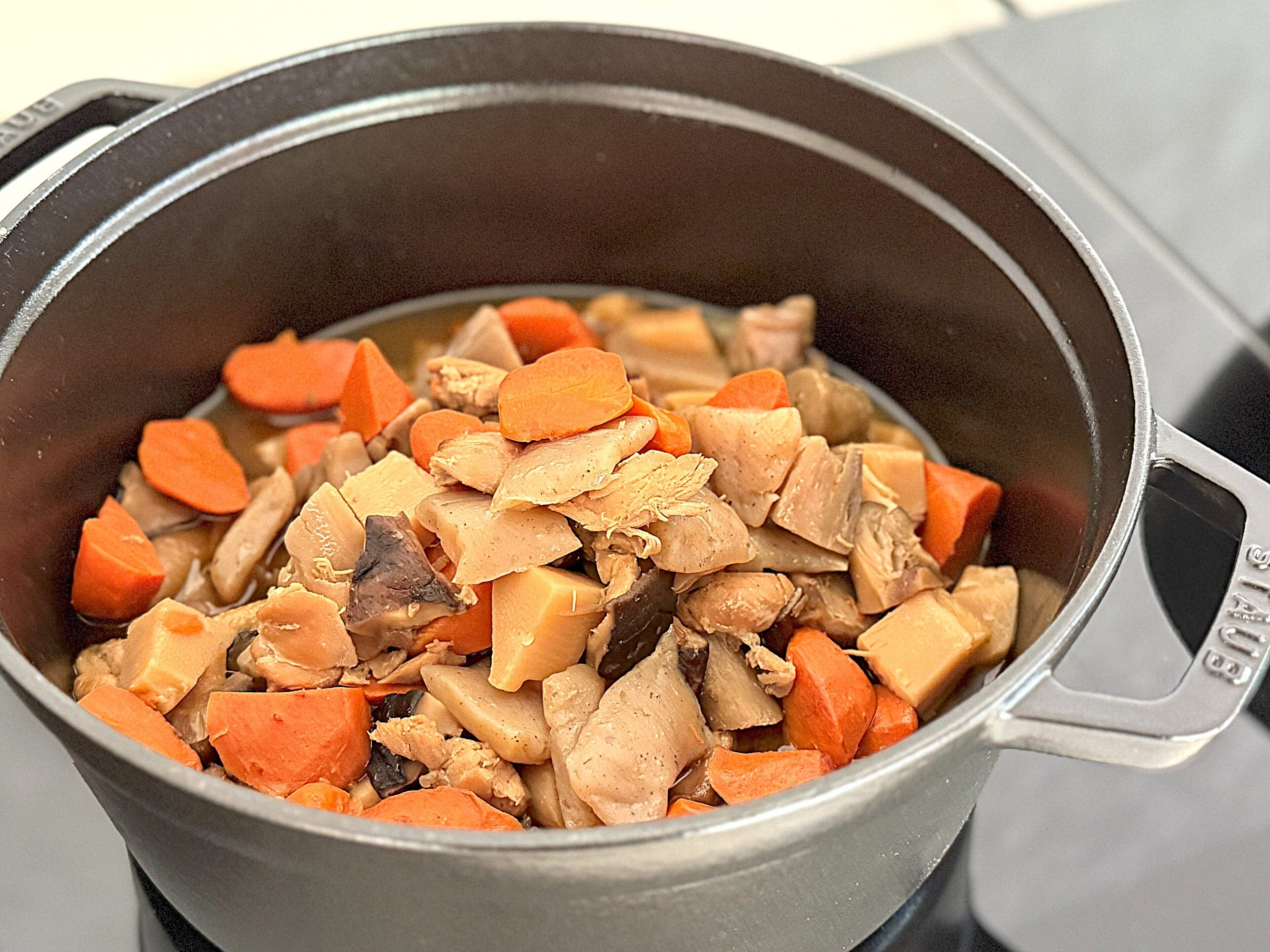 A pot containing a stew with chunks of meat and vegetables.