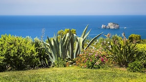A coastal garden with a view of the sea and a rocky outcrop. - Villa Le Rondini - Two Bedroom Villa, Sleeps 4 (Ionian Islands)