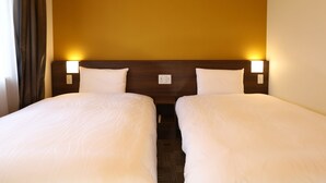 A hotel room with two beds, a wooden headboard, and bedside lamps. - Dormy Inn Ikebukuro Hot Springs (Tokyo)