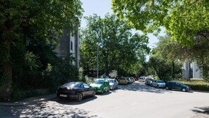 A street lined with parked cars and trees. - Apartment Marina (Dubrovnik)