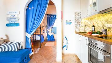 Cottage | Private kitchen | Full-sized fridge, oven, stovetop, electric kettle