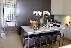 Enjoy cooking in this kitchen with a central island, stainless steel sink, and stove.