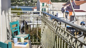 A balcony with a view of houses and a mountain.