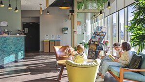 A reception area with a counter, seating, and a large window.