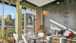 A modern interior with a dining area, seating, and a large window with a view of the outside.