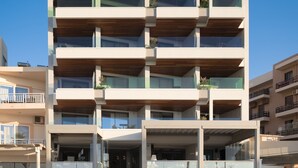A modern hotel with multiple balconies and a prominent sign reading "BIO BEACH Boutique Hotel". - Bio Beach Boutique Hotel (Rethymno)