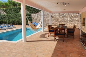 A heated pool, sun loungers