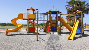 A playground with multiple slides and climbing structures.