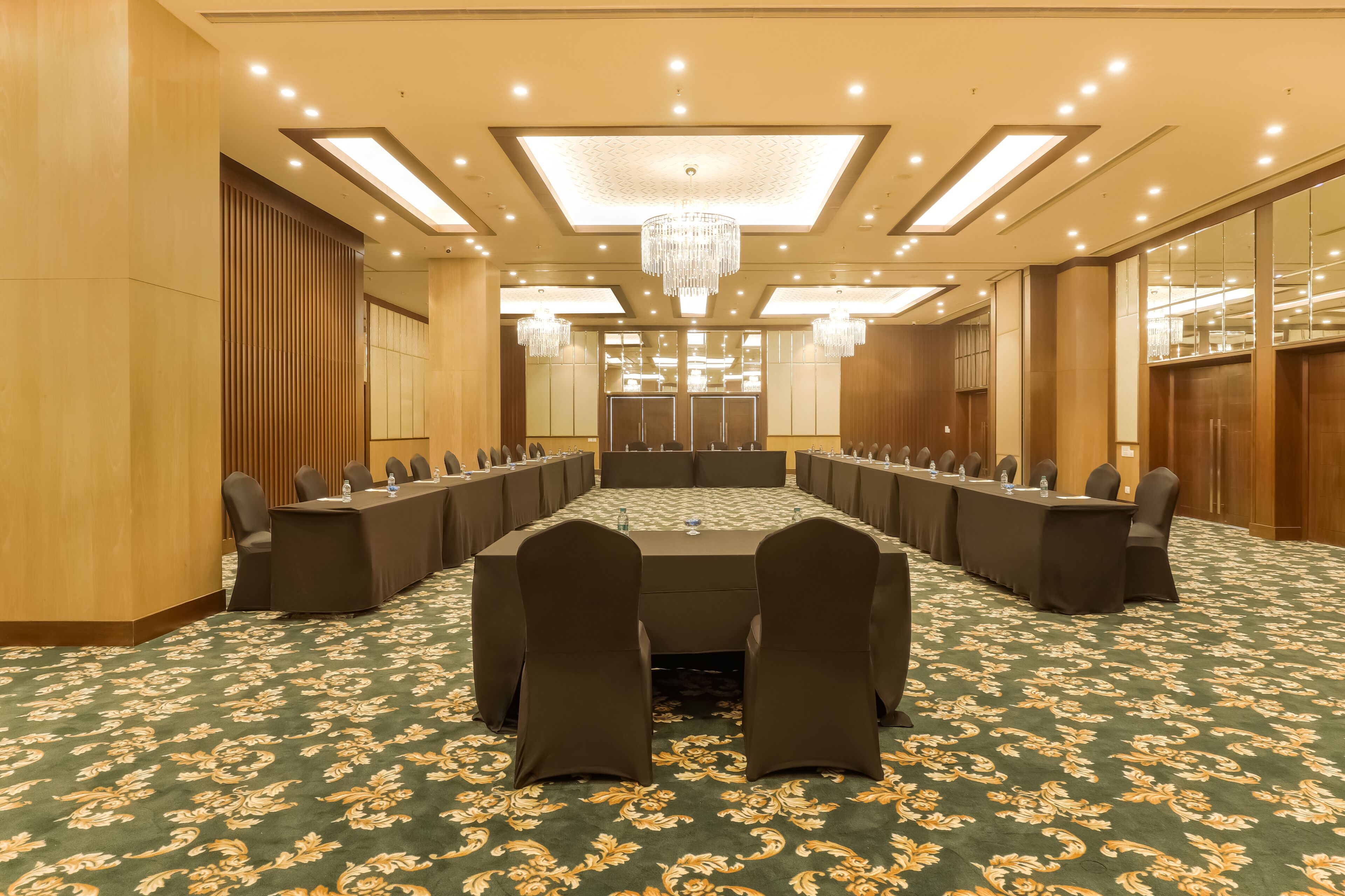 A conference room with a long table, chairs, and a chandelier.