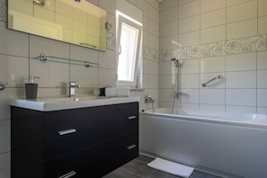 Bathtub, hair dryer, towels, soap