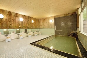 A wooden interior with a large bathtub, multiple sinks, and a tiled floor. - Oze Kogen Hotel (Katashina)