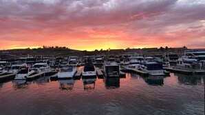 A marina with multiple boats docked under a sunset sky. - Red Rock Retreat (Page)