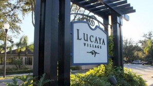 A sign for Lucaya Village with a pergola structure. - Lucaya 4 Bedrooms 3 Baths Townhome in Gated Community (Kissimmee)