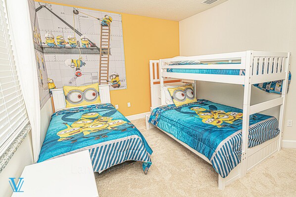 A bunk bed room with a Minion-themed bedspread and pillows, a ladder, and a wall with a Minion mural. - Kids-Friendly, Family-Friendly 3BD Deluxe Townhome 1603 (Clermont)