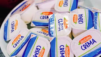 A plate of packaged yogurt with the brand name 'Lactolac Crema' visible.