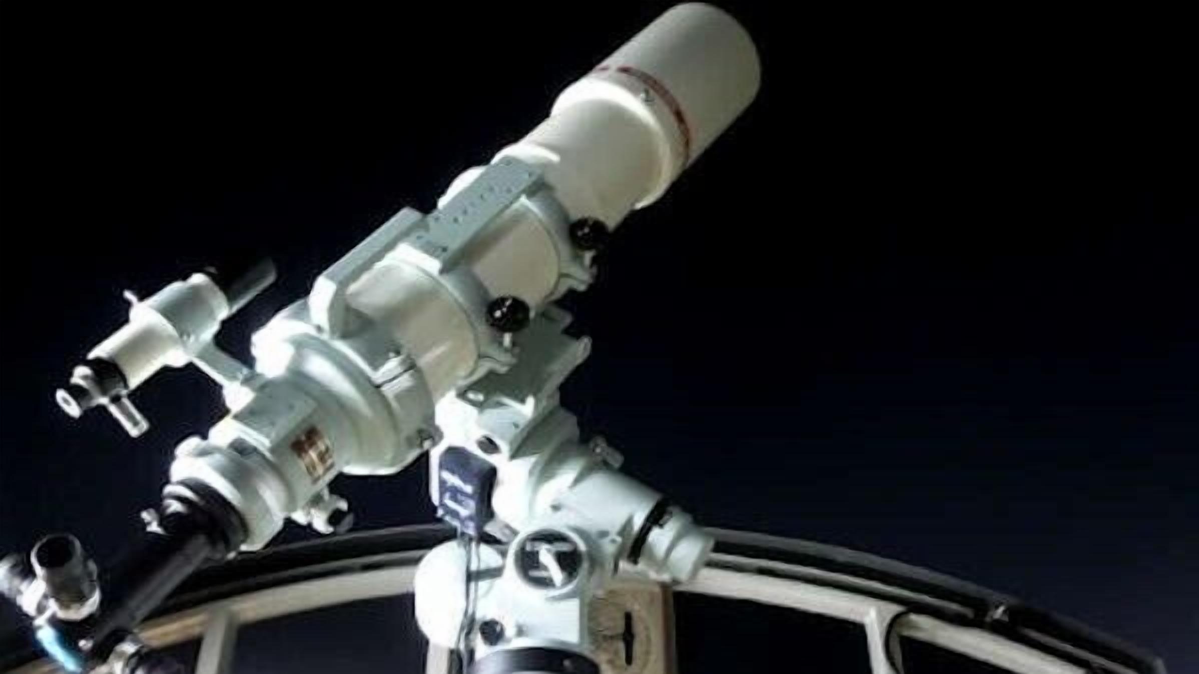 A telescope mounted on a structure, likely part of a space station or observatory.