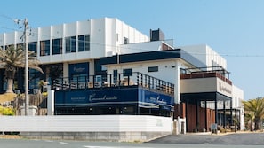 A modern building with a restaurant named 'Cousins Marin' on the ground floor. - Irago Hotel & Resort (Tahara)