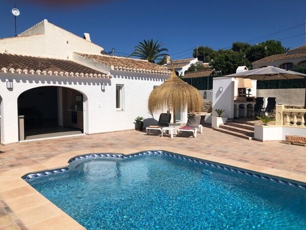 A heated pool, pool loungers