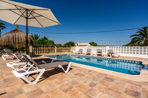 A heated pool, pool loungers