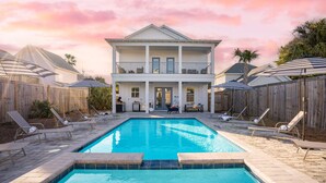 A two-story house with a swimming pool, surrounded by wooden fences and lounge chairs. - Sleeps 20! 5 Min Walk to Beach, Private Pool & Hot Tub, 8BDR | Lyle by AvantStay (Destin)