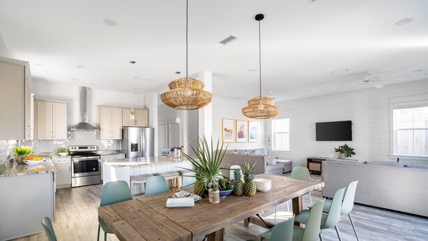 A spacious kitchen with a wooden dining table, green chairs, and modern appliances. - Sleeps 20! 5 Min Walk to Beach, Private Pool & Hot Tub, 8BDR | Lyle by AvantStay (Destin)