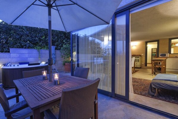 Enjoy al fresco dining on the patio with a barbecue grill and comfortable seating.