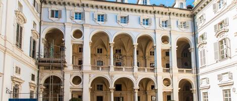 A historic building with multiple arches and balconies, likely a hotel or public building.