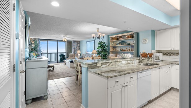 A spacious kitchen with a large island, white cabinetry, and a view to the outside. - Ocean Bay Club 1508-Oceanfront 3BR-Great Amenities (North Myrtle Beach)