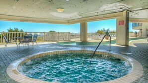 A hot tub with a tiled edge, surrounded by a brick patio. - Ocean Bay Club 1508-Oceanfront 3BR-Great Amenities (North Myrtle Beach)