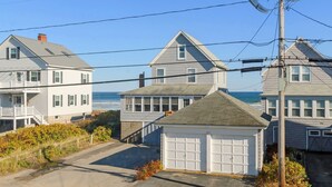 A coastal residential area with houses, a garage, and a view of the ocean. - Buoy Beach House Wells (Wells)