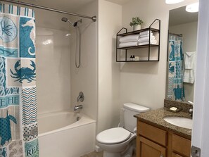 A bathroom with a shower, toilet, and sink. -  Destin's Salty Beach Paradise! (Destin)