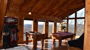 Relax in a spacious cabin with a pool table, foosball table, and scenic views of the surrounding landscape.