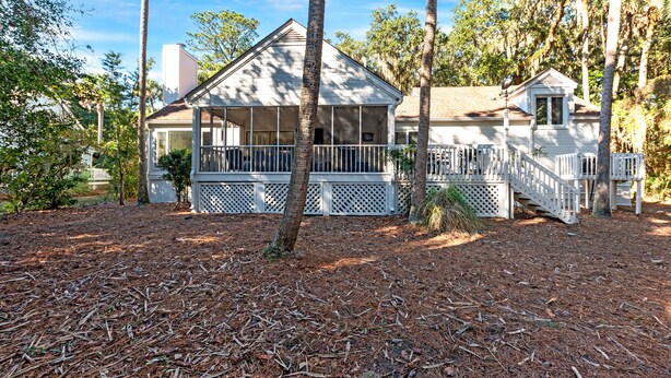 A house with a porch, a covered front area, and a small attached structure.