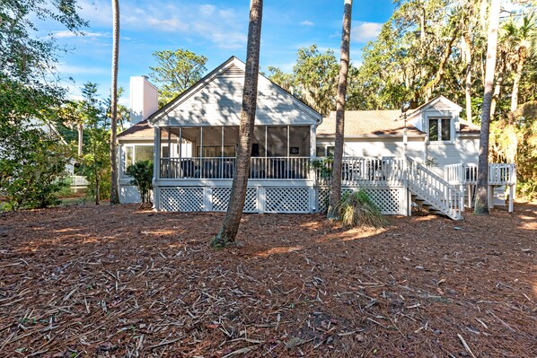 A house with a porch, a covered front area, and a small attached structure.