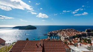 A coastal town with terracotta rooftops, a historic fortification, and a clear view of the sea. - Guesthouse Home Sweet Home - Double Room with Shared Terrace (Dubrovnik)