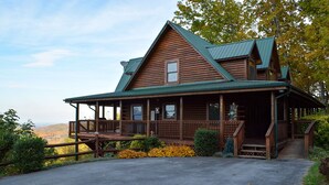 A wooden cabin with a porch, a covered entryway, and a scenic view. - Grand Vista Lodge - Cabin (Sevierville)