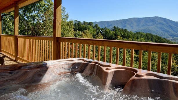 A hot tub with a wooden deck and a mountain view. - Little Feather - 1 Level Cabin (Sevierville)