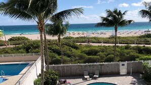 A pool area with lounge chairs and a view of the beach. - Directly on the beach with Free beach lounges.  Best location in South Beach! (Miami Beach)