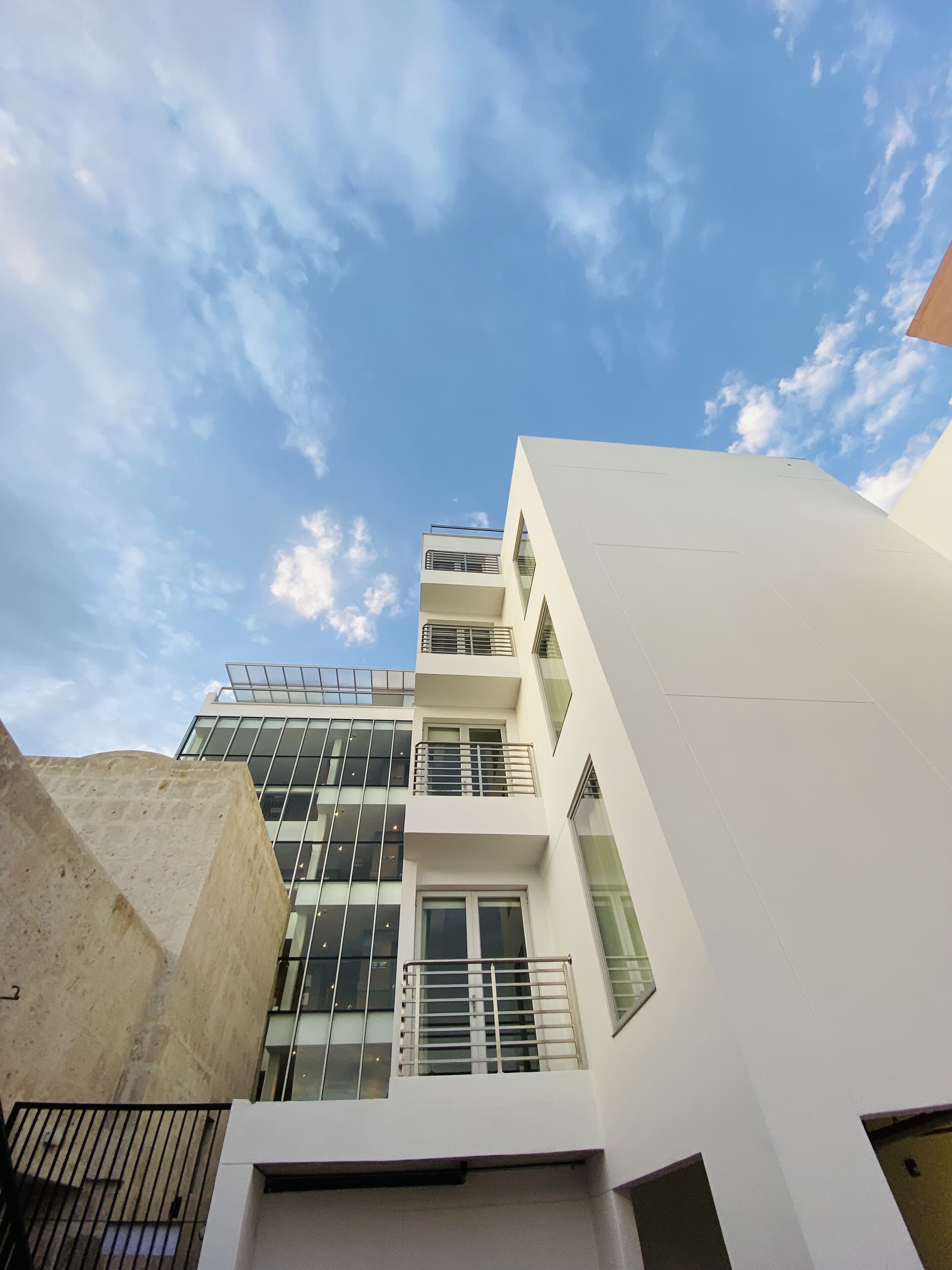 A modern building with multiple floors, large windows, and a flat roof.