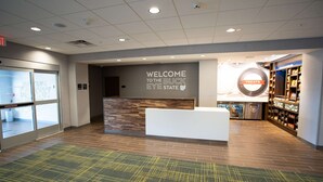 A reception area with a 'Welcome to the Buck Eye State' sign, a reception desk, and a 'Treats' display.