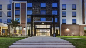 A Hilton Garden Inn with a modern facade, large windows, and a well-lit entrance. - Hilton Garden Inn Madison Huntsville Airport (Madison)