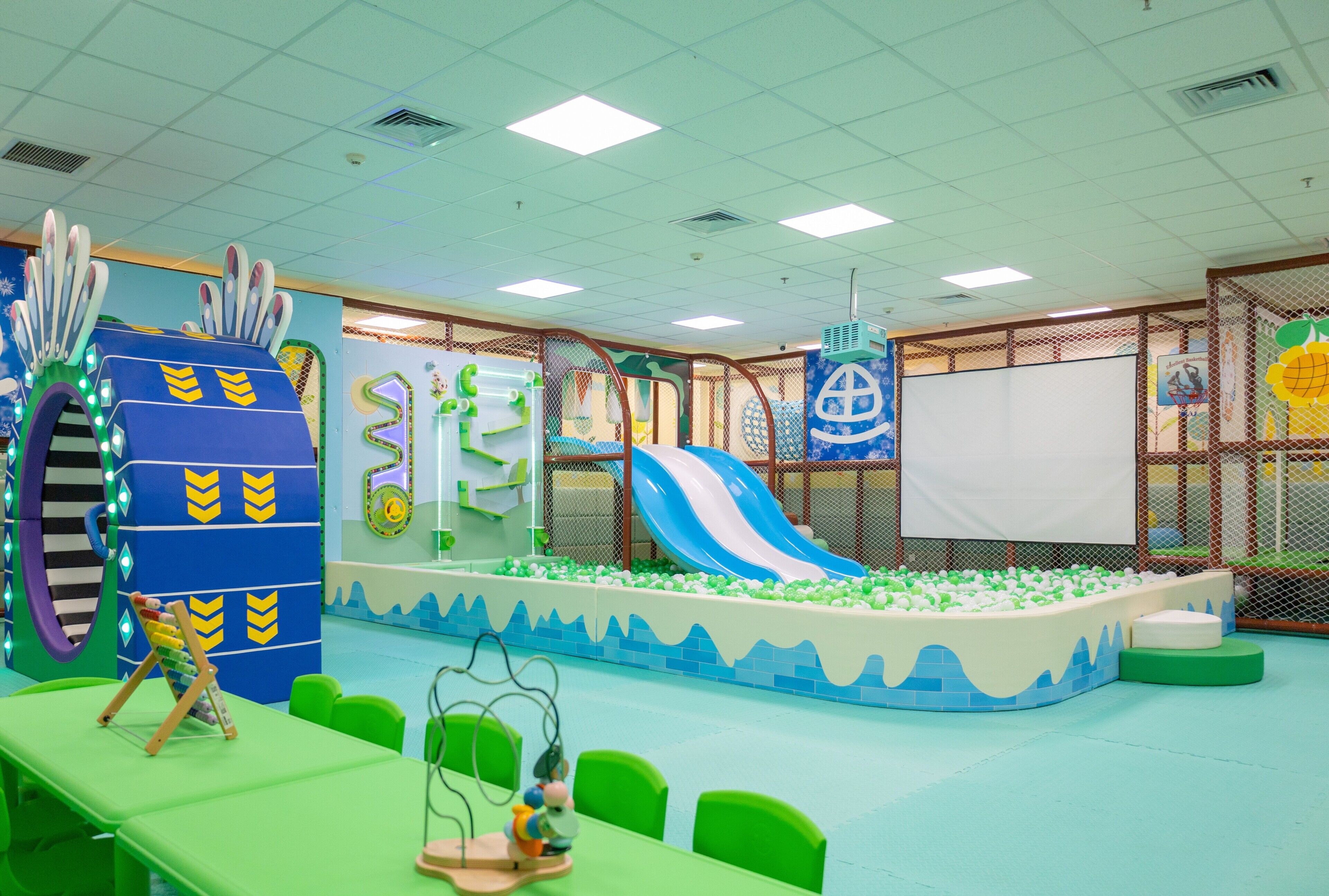 A children's play area with a slide, ball pit, and various play structures.