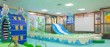 A children's play area with a slide, ball pit, and various play structures.